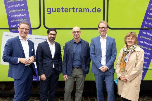 Projektpartner*innen des Forschungsprojekts „LastMileTram RheinMain V“ vor der VGF Gütertram (v.l.): Prof. Dr. Kai-Oliver Schocke, Präsident der Frankfurt UAS und Projektleiter, Kaweh Mansoori, Hessischer Minister für Wirtschaft, Energie, Verkehr, Wohnen und ländlichen Raum, Andre Lütgeharm, Regional Director Operations, Amazon Logistics, Stadtrat Wolfgang Siefert, Mobilitätsdezernent der Stadt Frankfurt, und Kerstin Jerchel, Arbeitsdirektorin und Geschäftsführerin, VGF. 